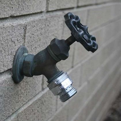 Outdoor faucet with a hose thread and wheel handle now with a threaded Vacuum breaker attached. 