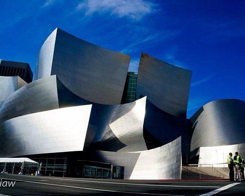 A large stainless steel building with a blue sky in the background