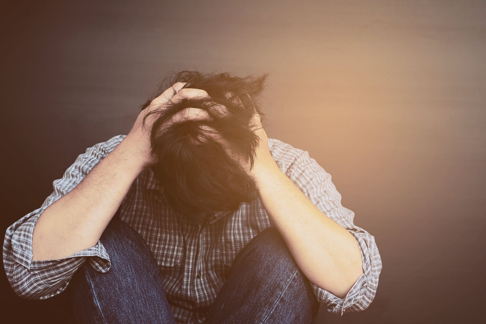 person holding their head in their hands