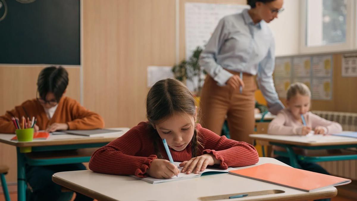 student writing on paper