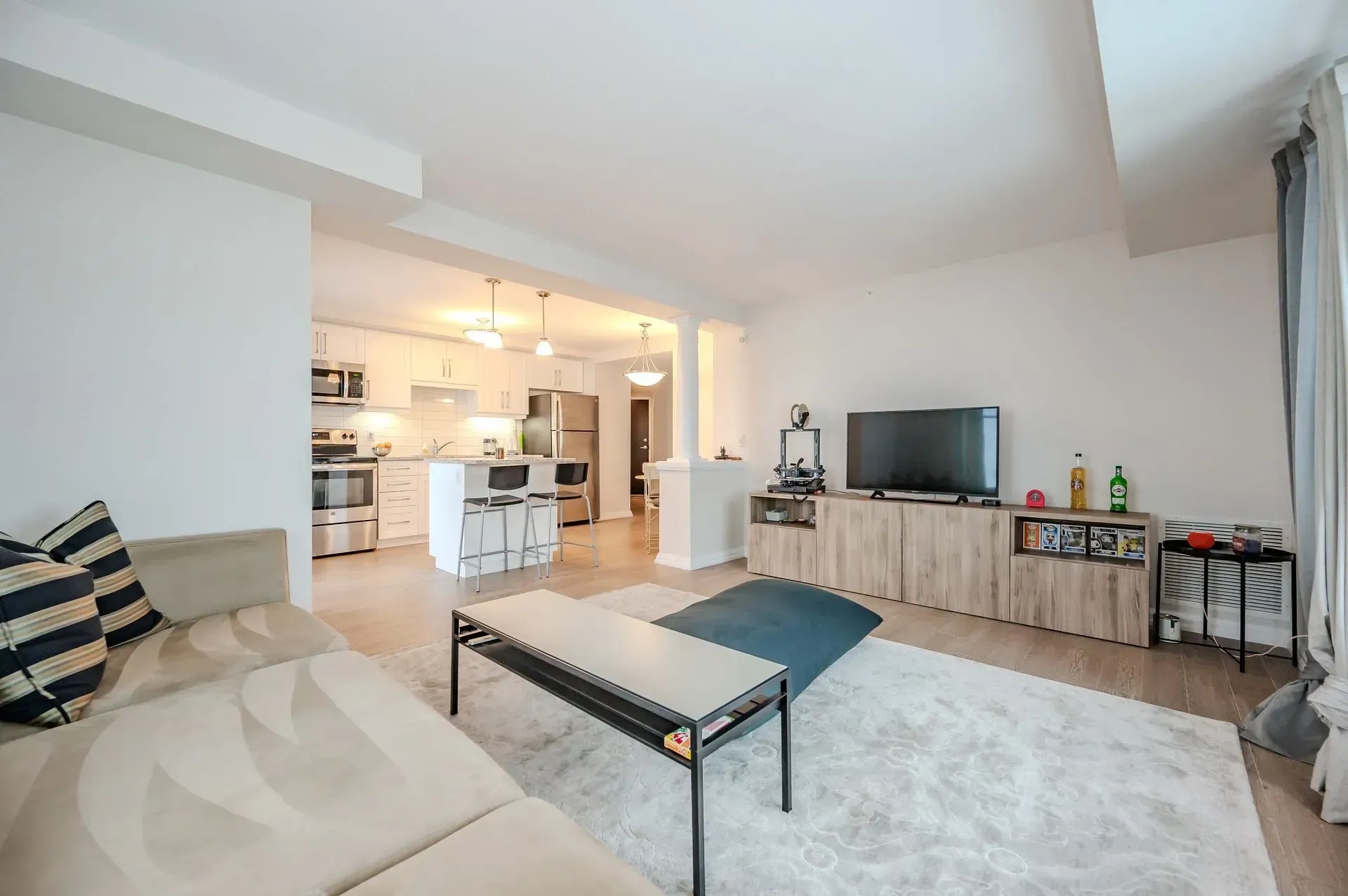A living room with a couch , coffee table , and television.