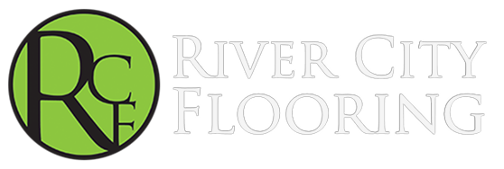 Logo for River City Flooring: green circle with black 