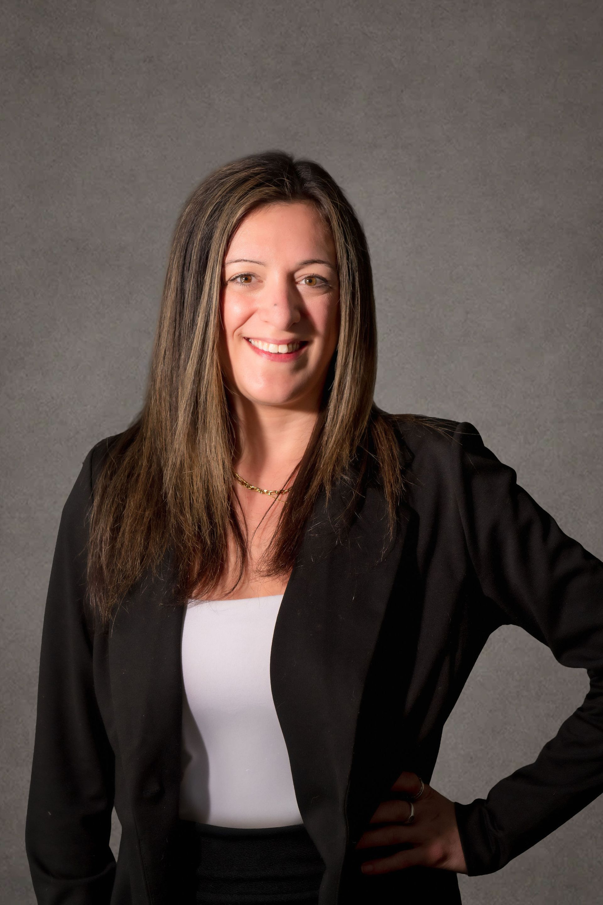 A professional headshot of Ashley Kevitt, Senior Attorney, a woman wearing formal clothes in front of a grey background