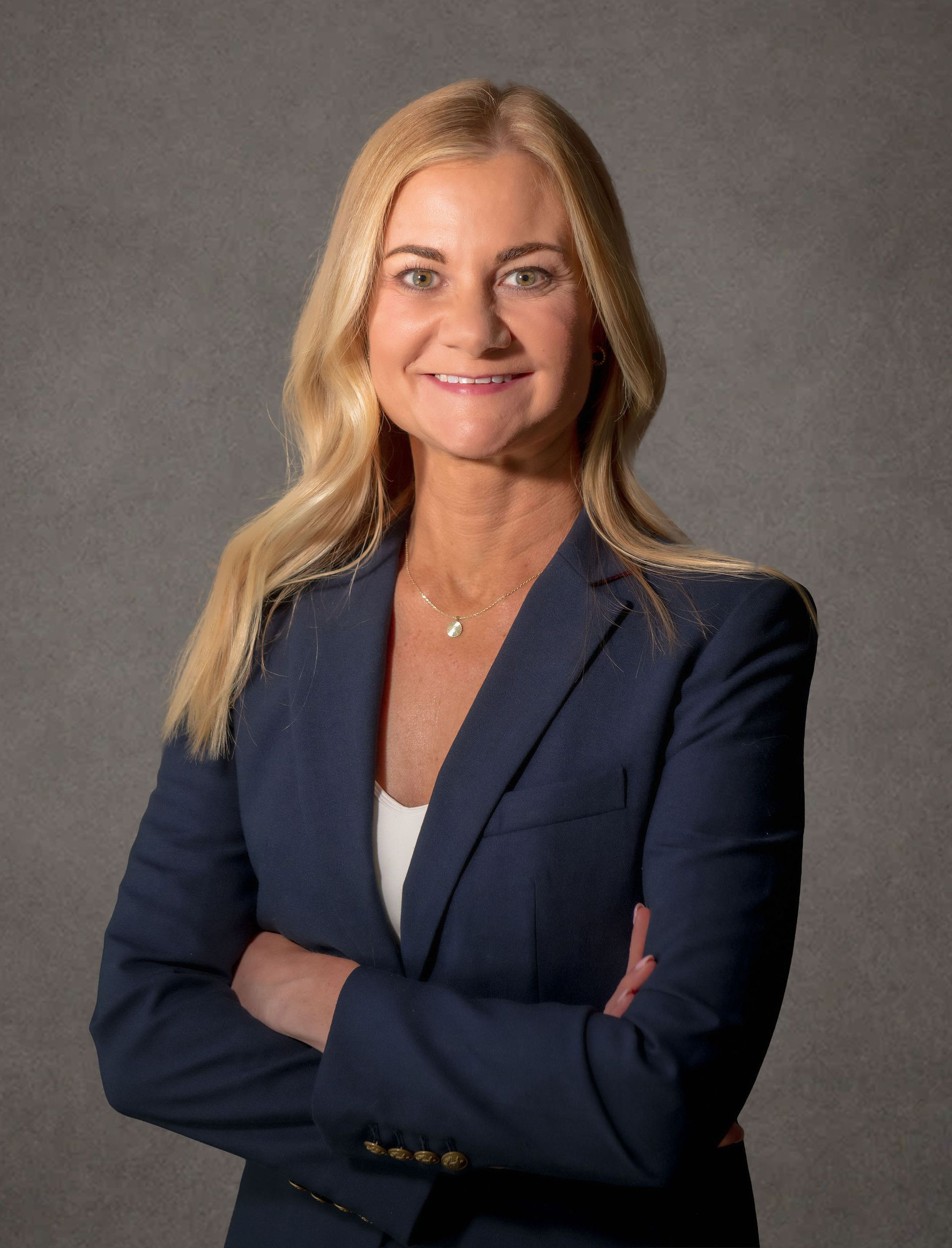 A professional headshot of Holly M. King, Senior Attorney, a woman wearing formal clothes in front of a grey background
