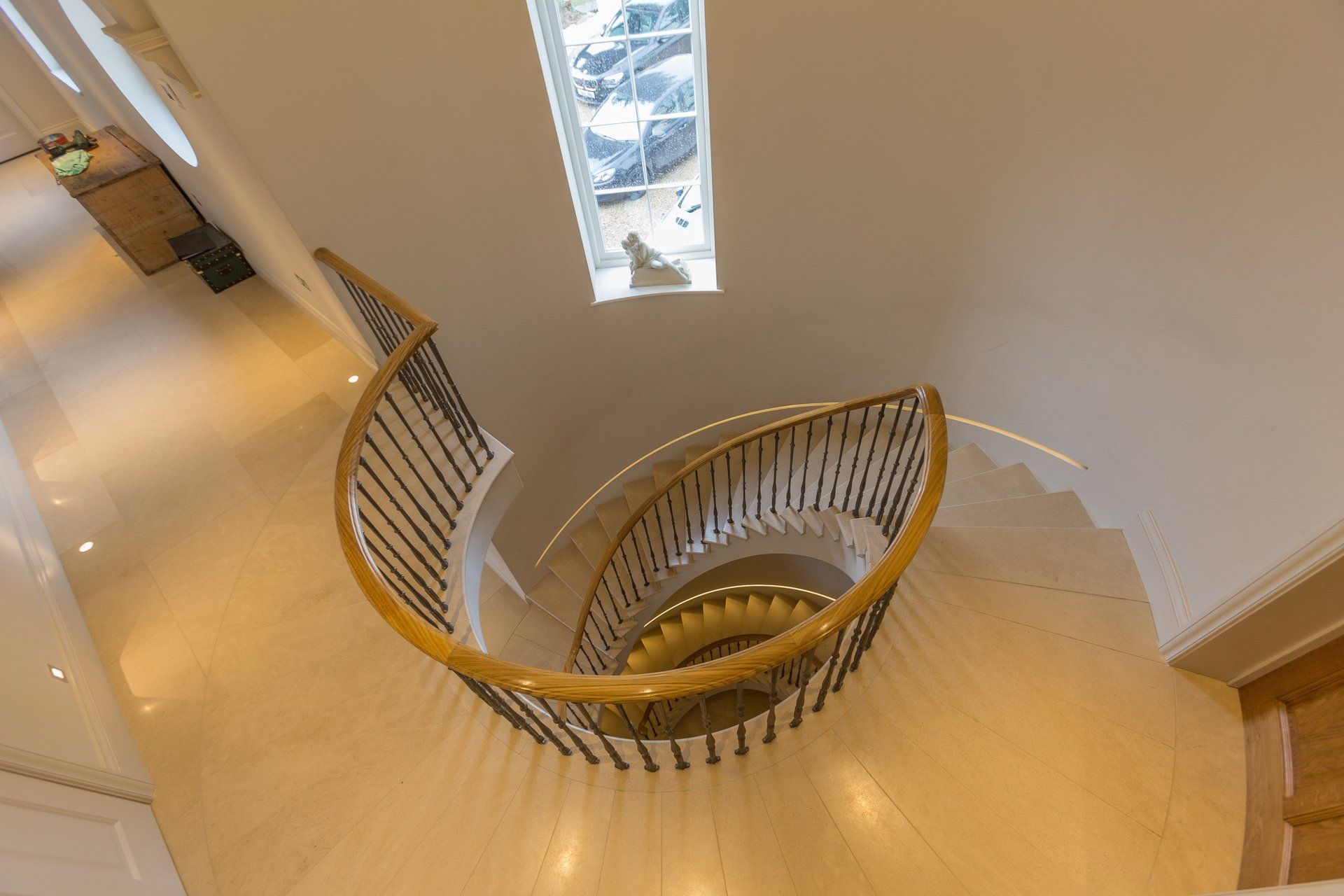 An aerial view of a spiral staircase with a wooden railing