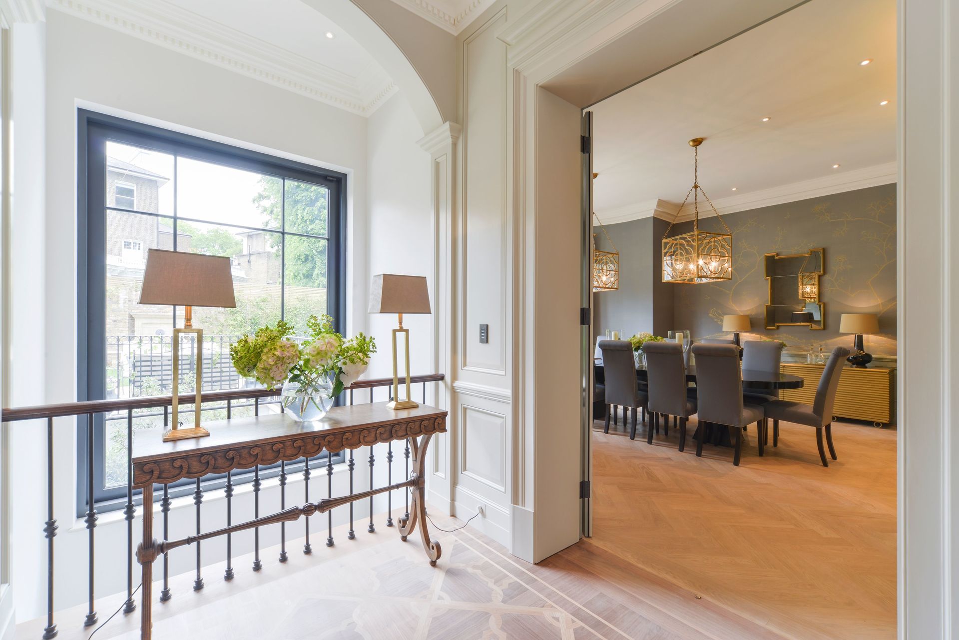 A hallway leading to a dining room with a table and chairs.