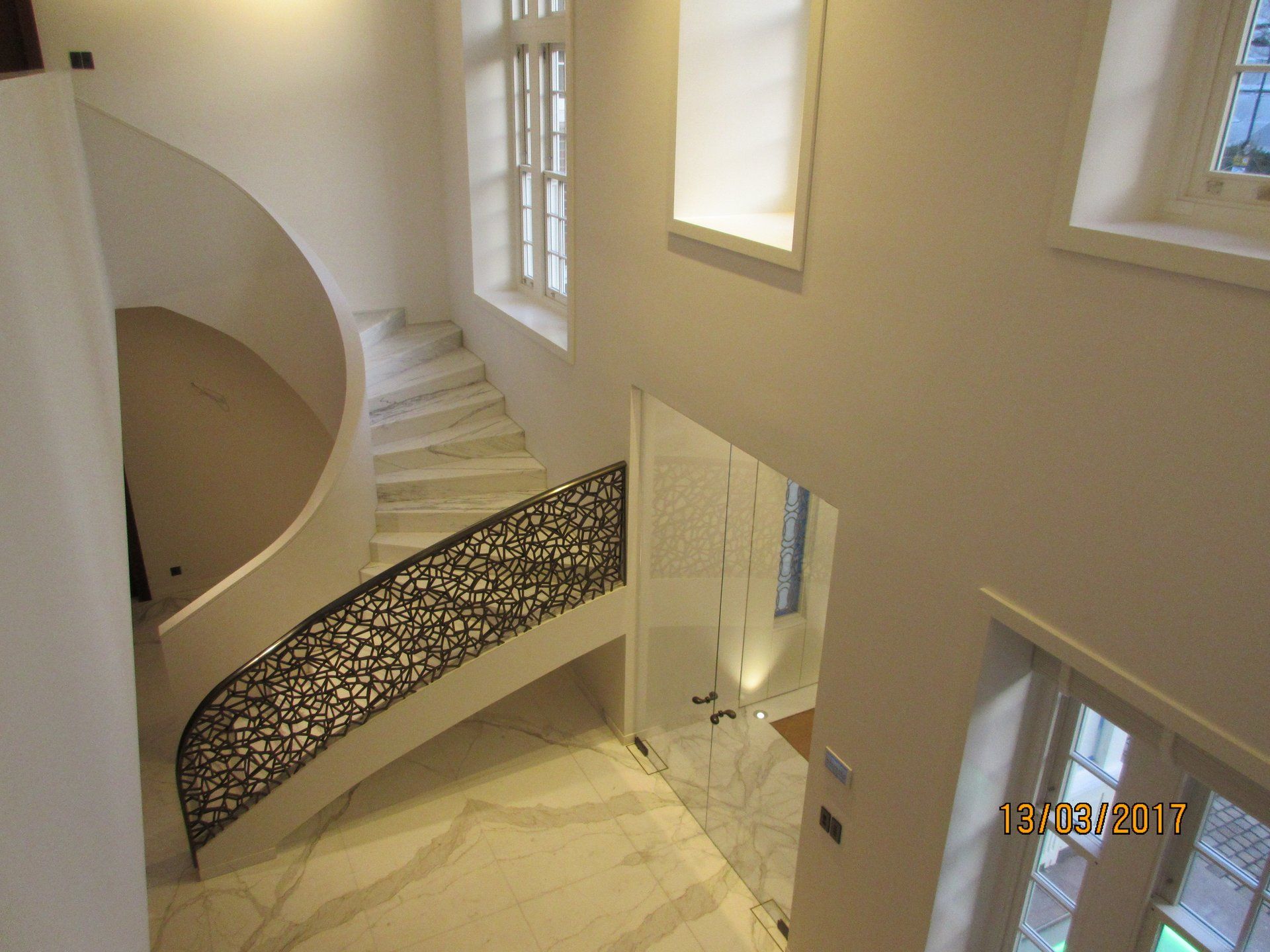 An aerial view of a spiral staircase with a wrought iron railing