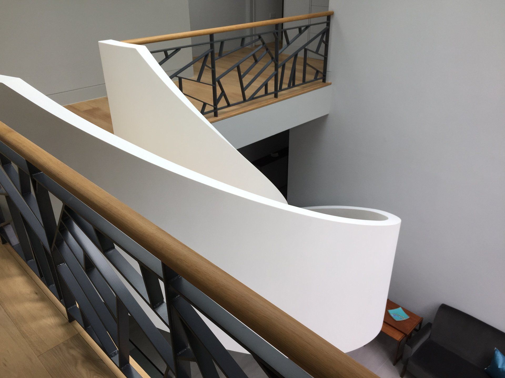 An aerial view of a staircase with a black railing