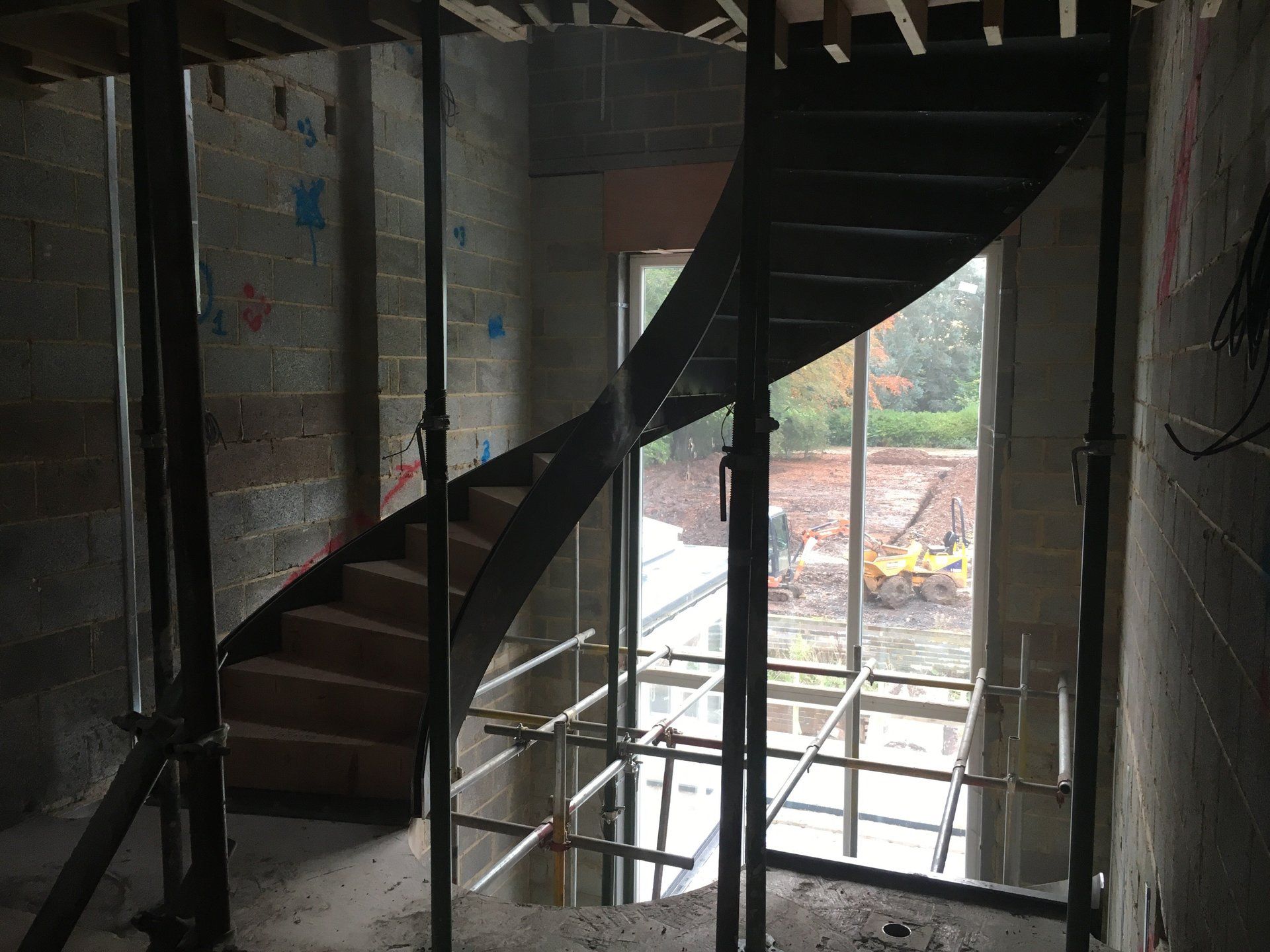 A spiral staircase in a building under construction