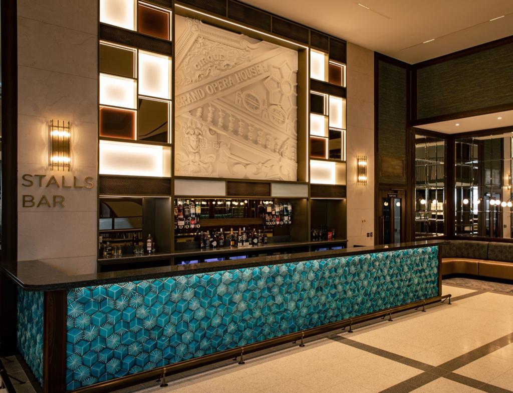 The stalls bar is located in the lobby of a hotel.