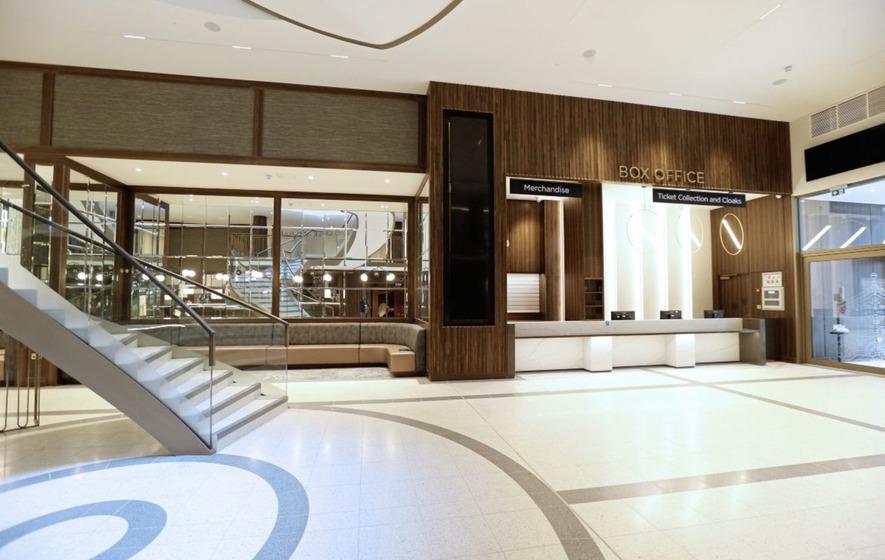 A large lobby with stairs and a reception desk