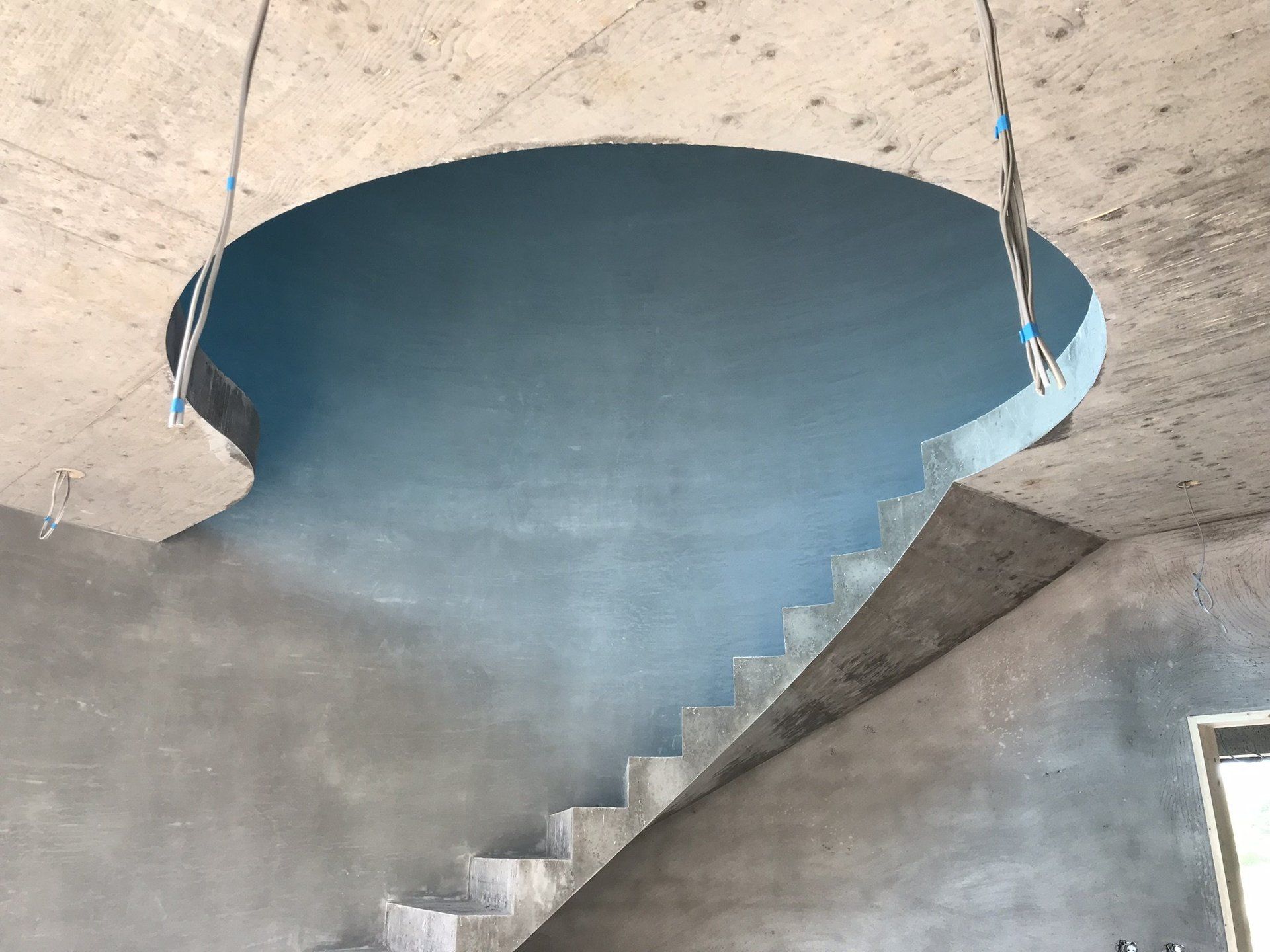 A spiral staircase is being built in a building.