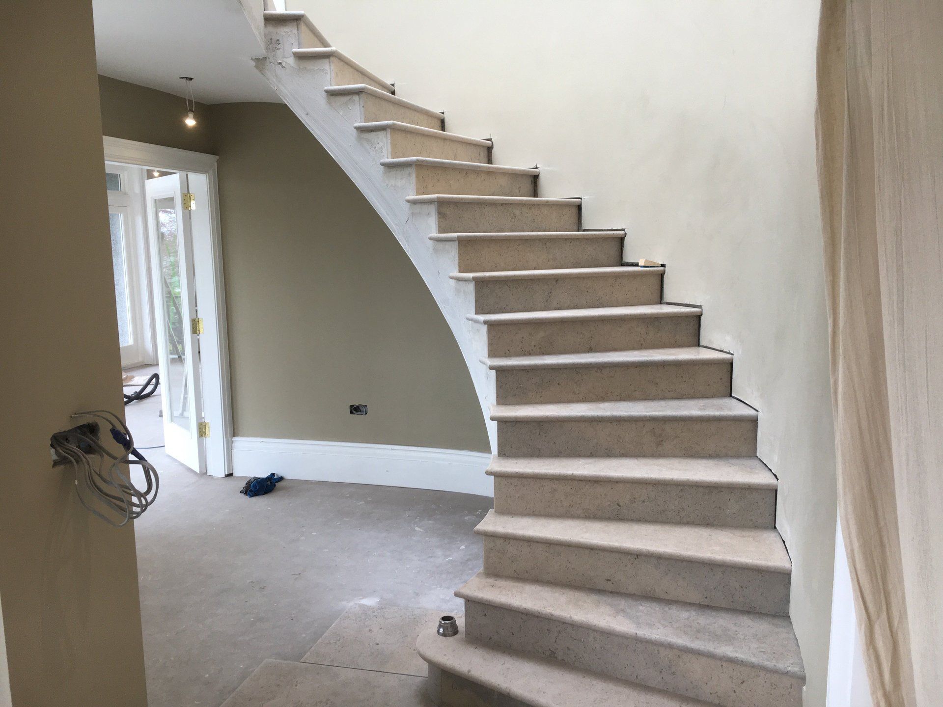 There is a staircase in the middle of a room.