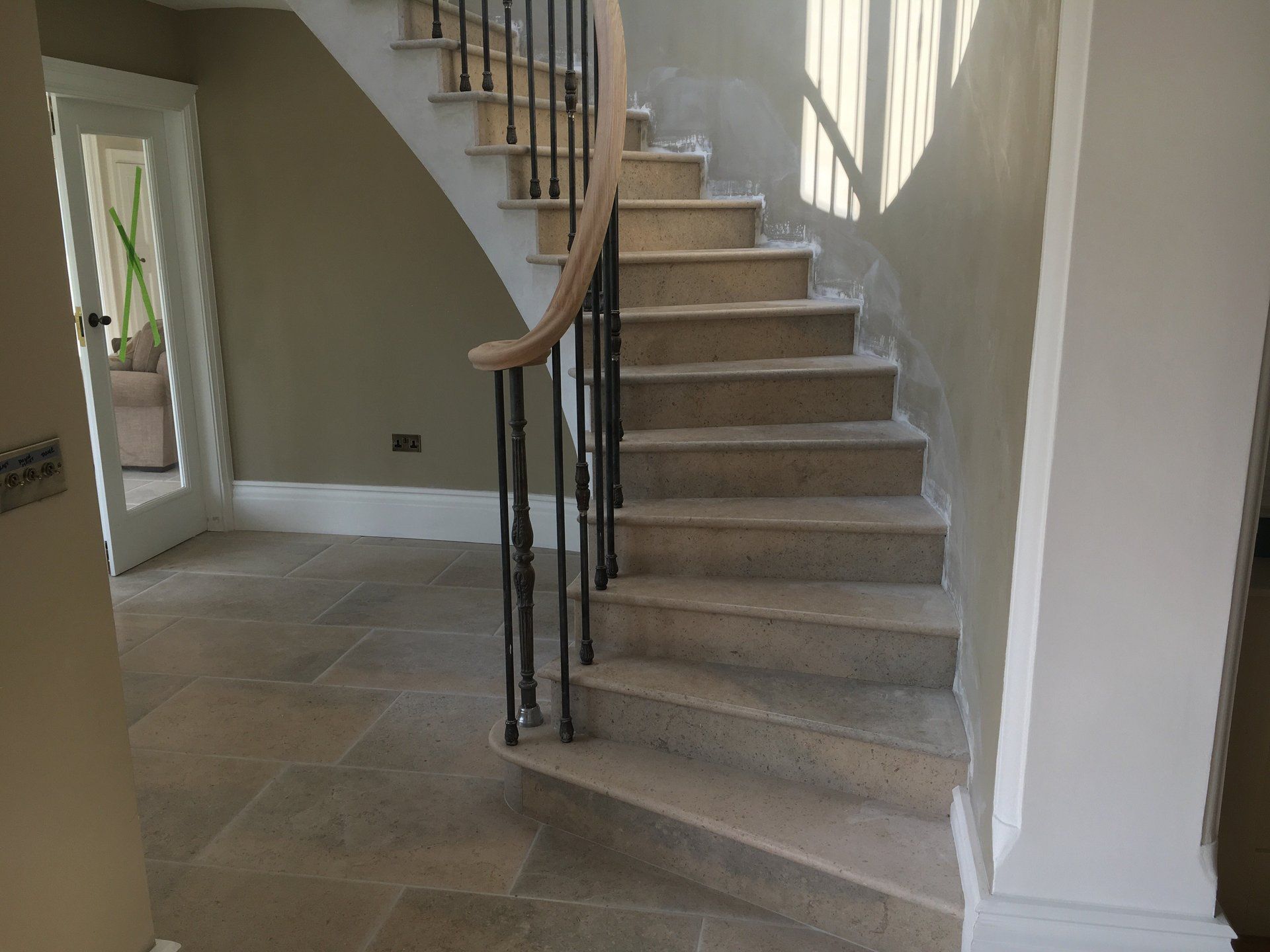 A staircase with a wrought iron railing in a house.