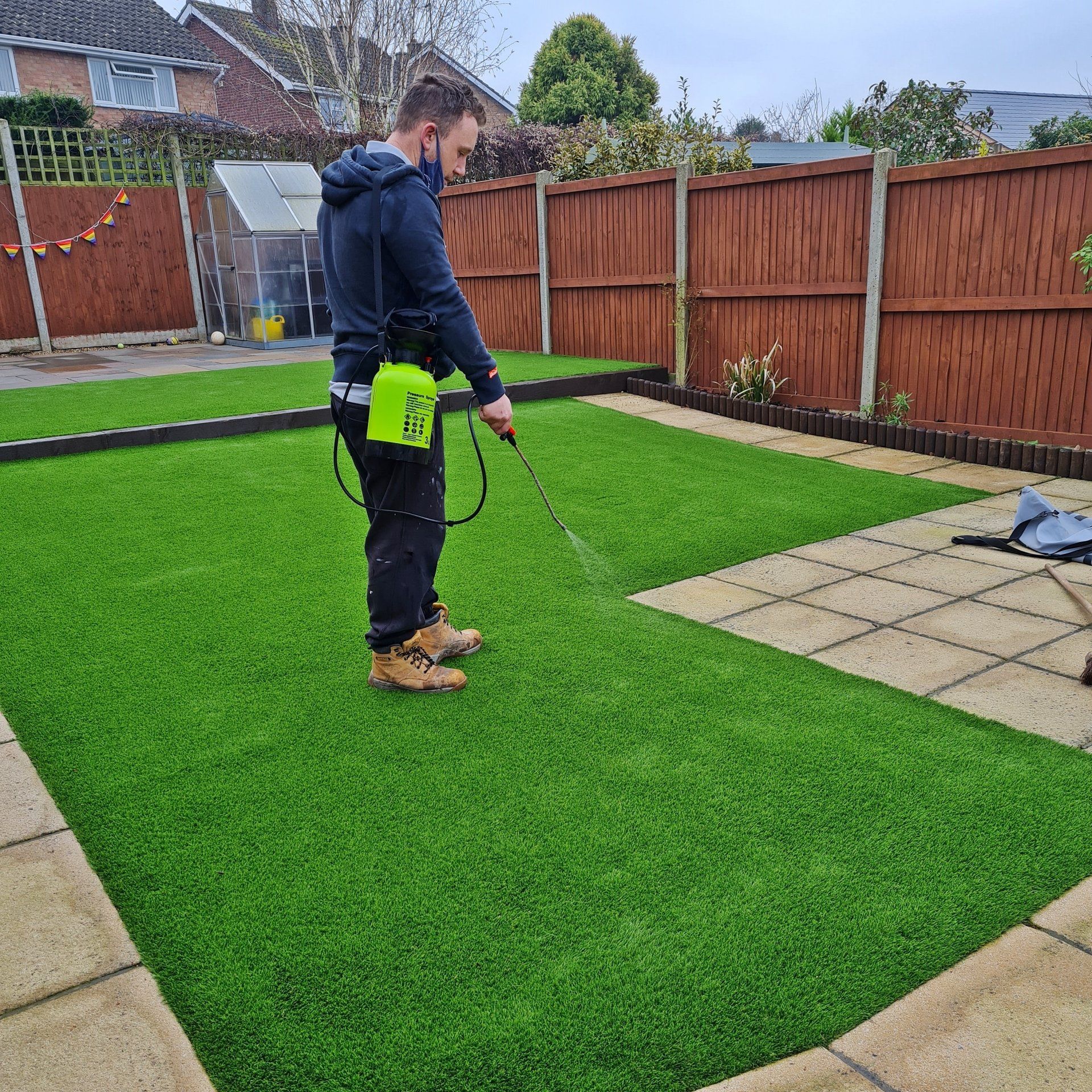 Artificial grass lawn maintenance services showing landscaping services equipment