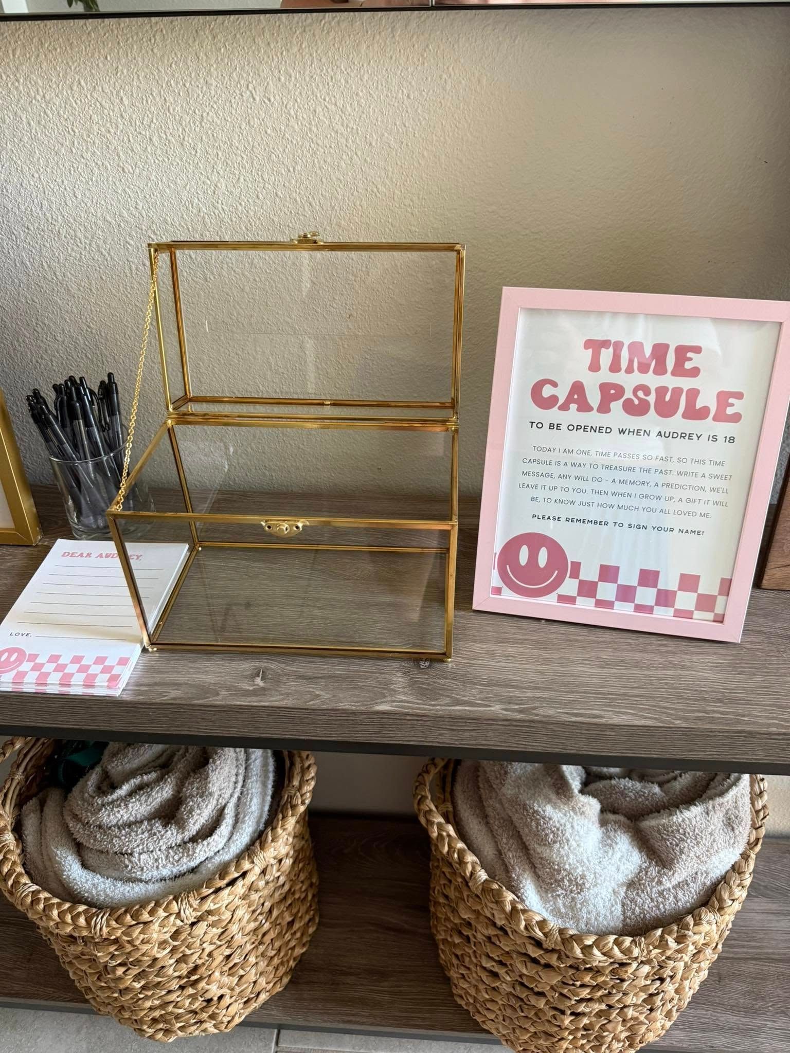 A table with wicker baskets and a sign that says `` time capsule ''.