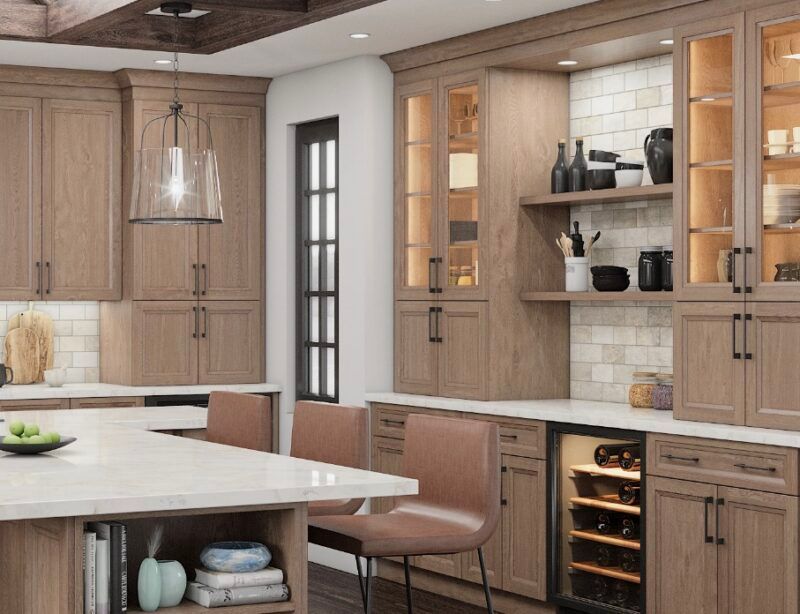 Modern kitchen with light wood cabinets, white countertops, and a wine cooler.