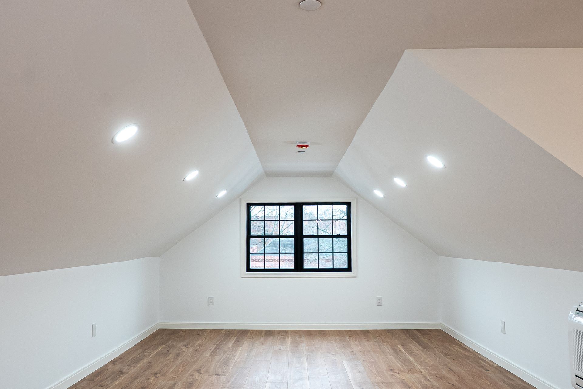 There is a window in the attic of a house