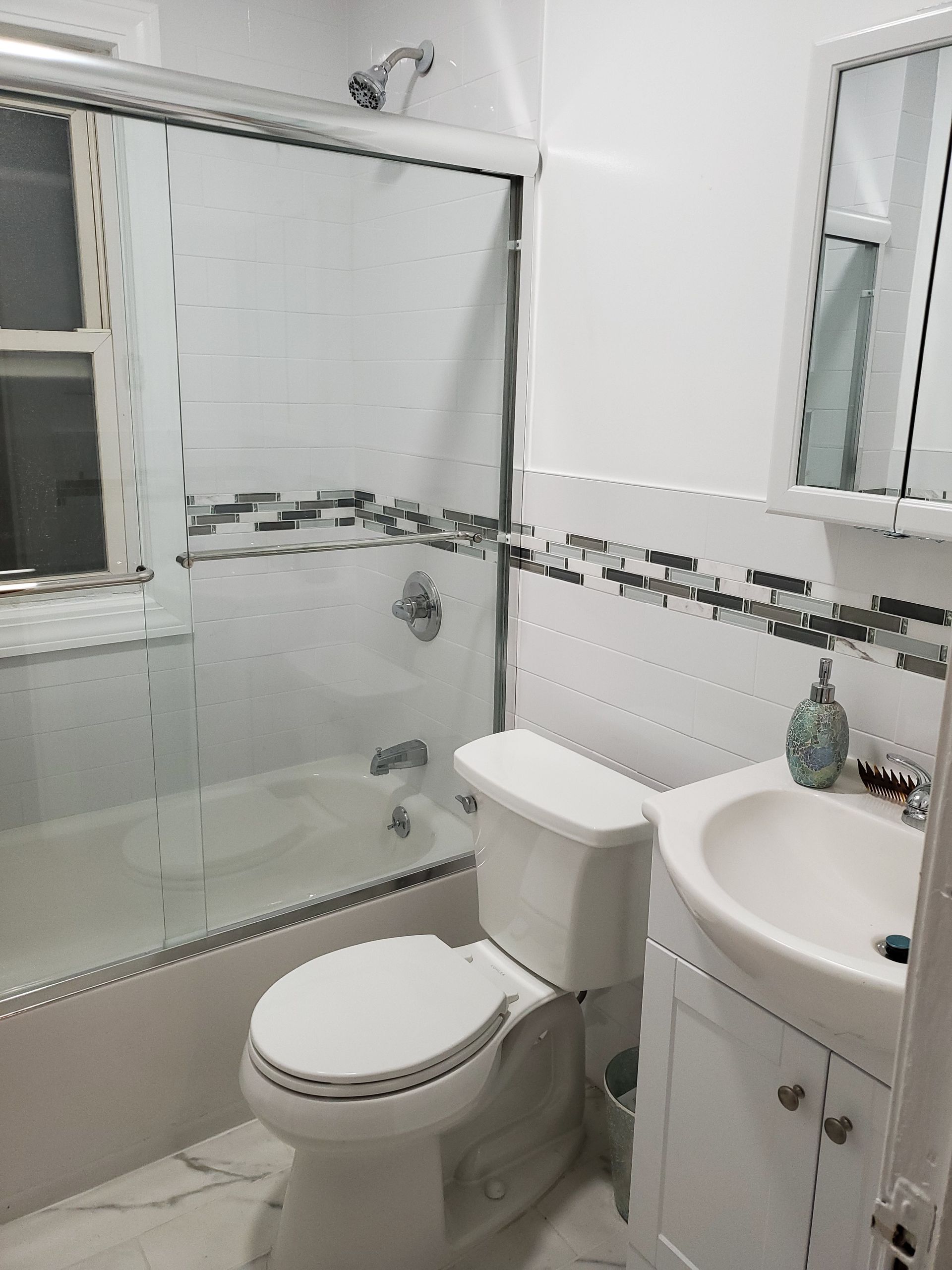 A bathroom with a toilet, sink, and shower