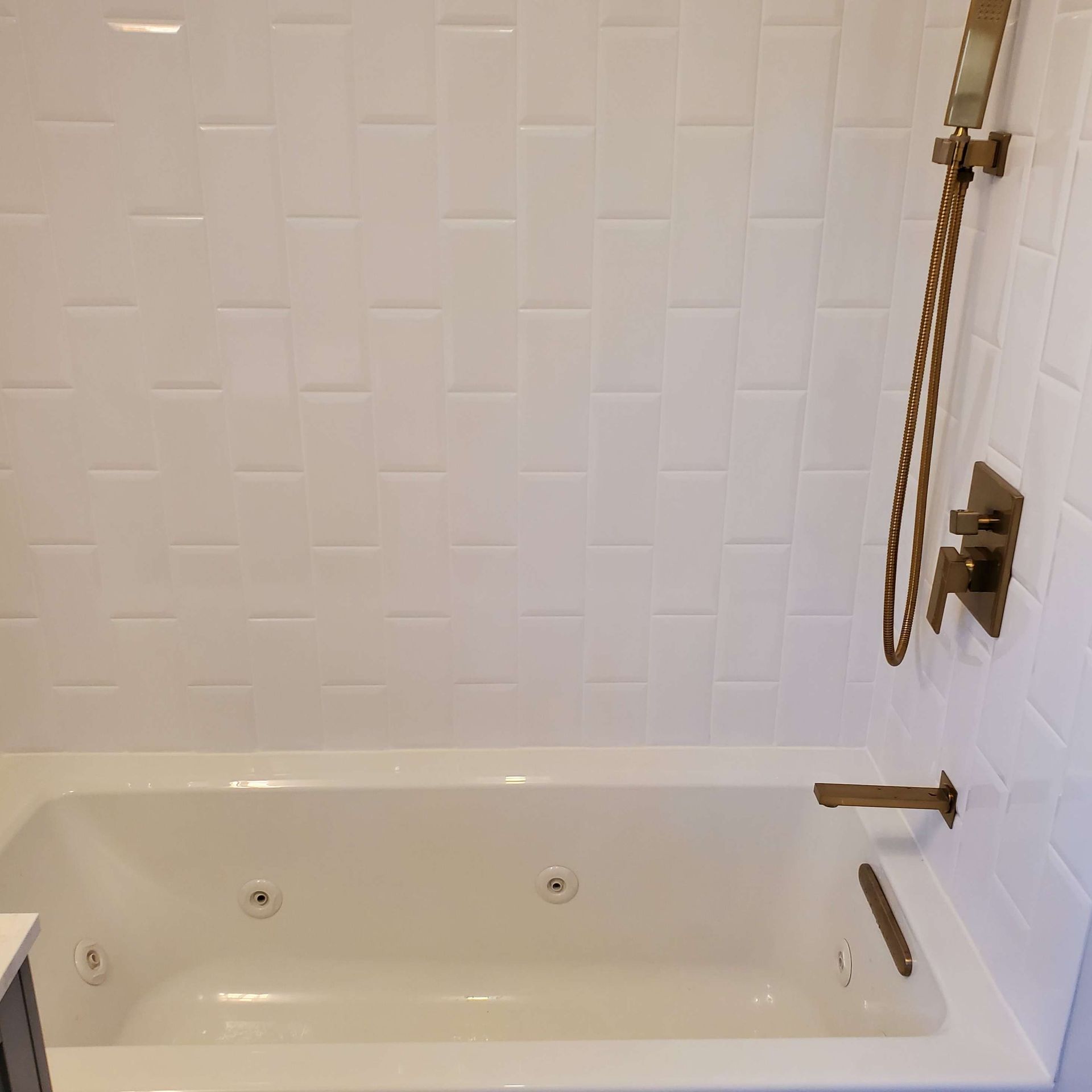 A bathtub with a shower head attached to it in a bathroom