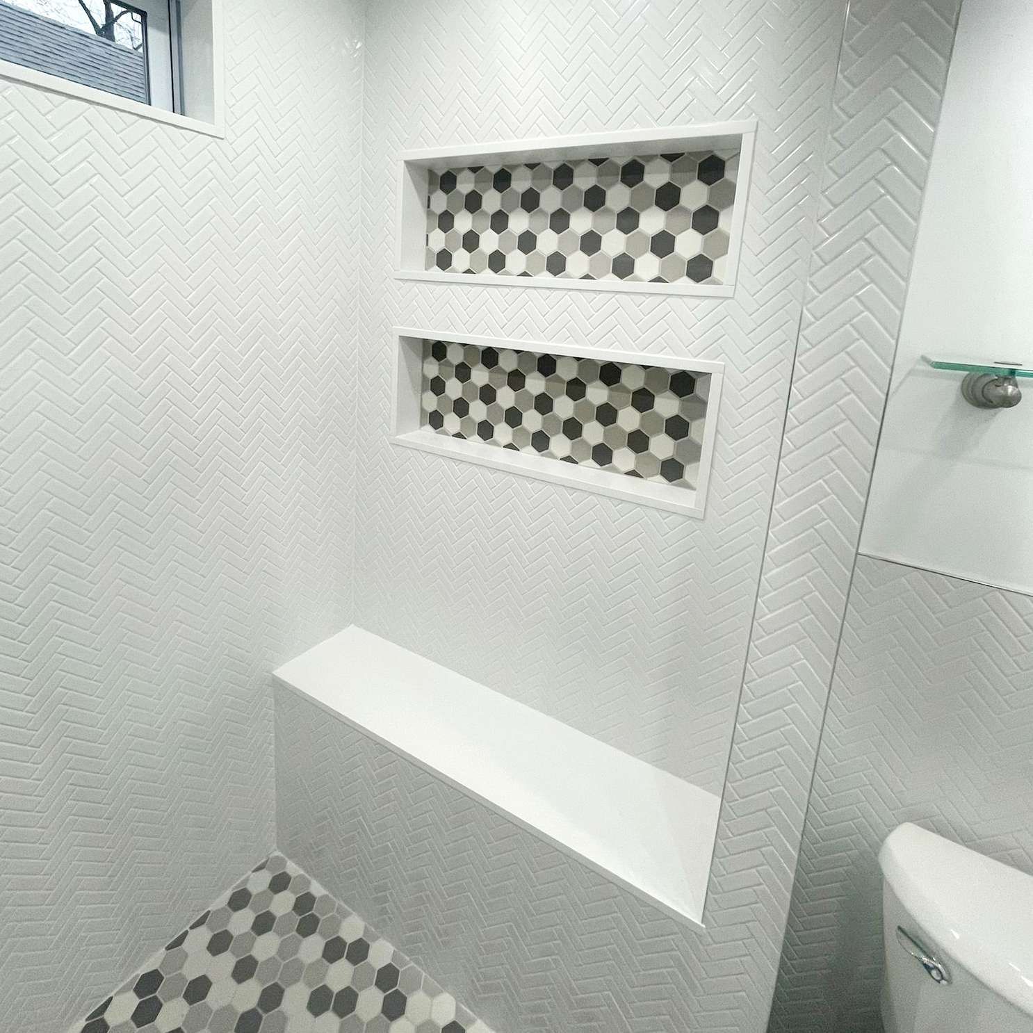 A bathroom with a toilet, sink, and shower