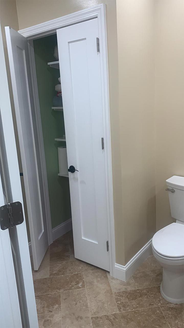 A bathroom with a toilet and a closet