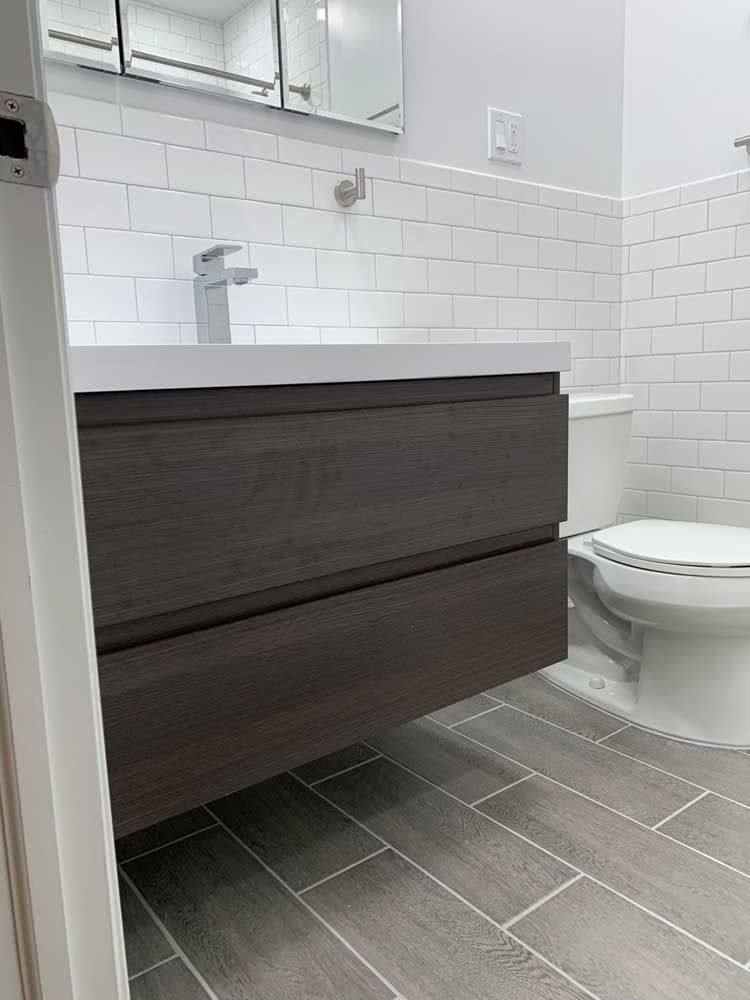 A bathroom with a sink, toilet and mirror