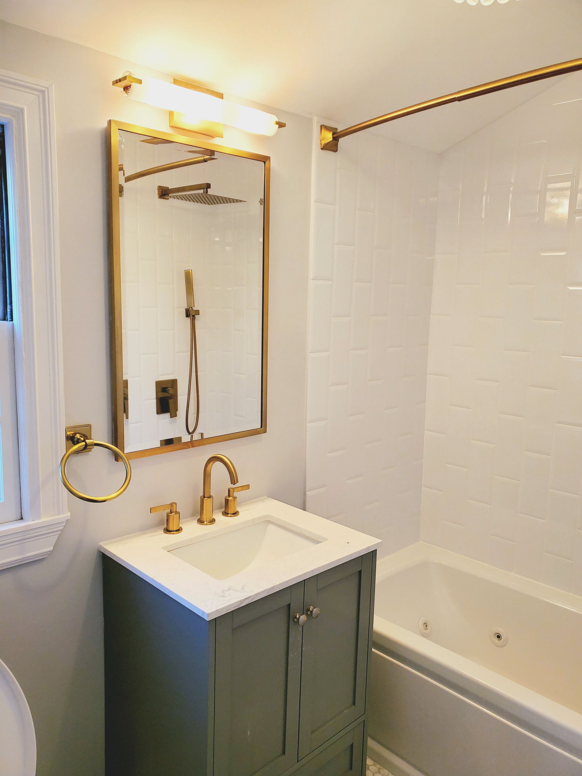 A bathroom with a sink, mirror, tub and shower