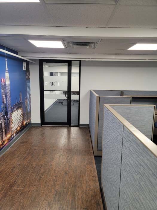 There is a picture of the new york city skyline on the wall of the office