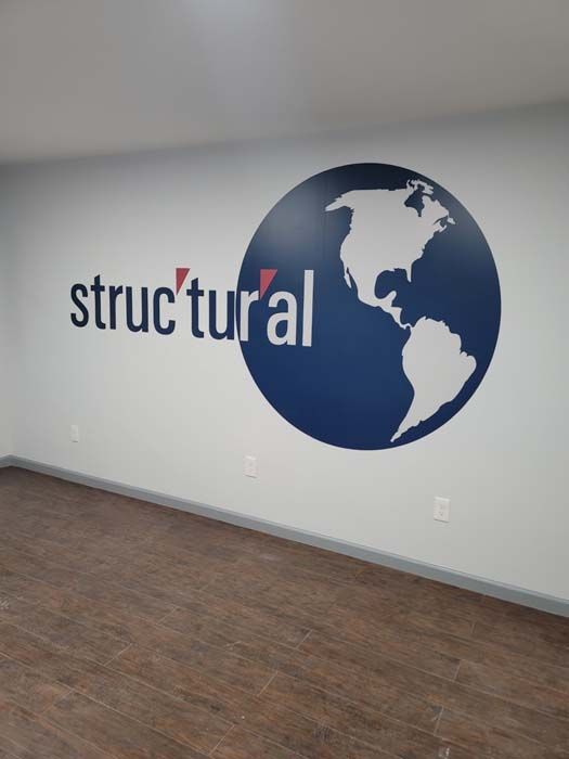 An empty room with a structural logo on the wall