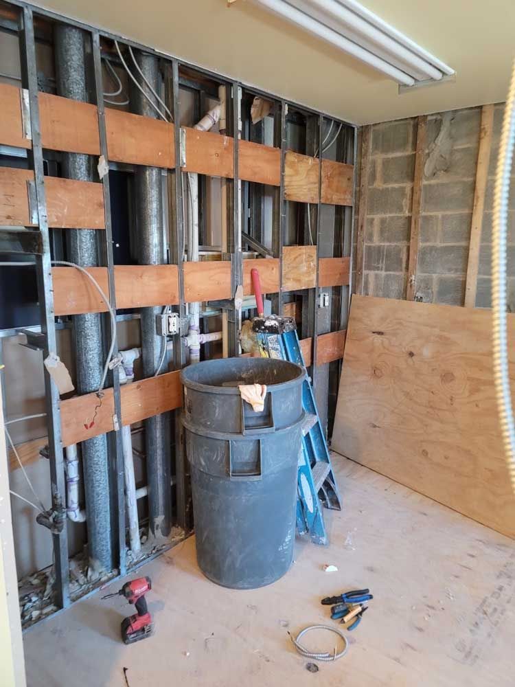 A room under construction with a bucket and a ladder