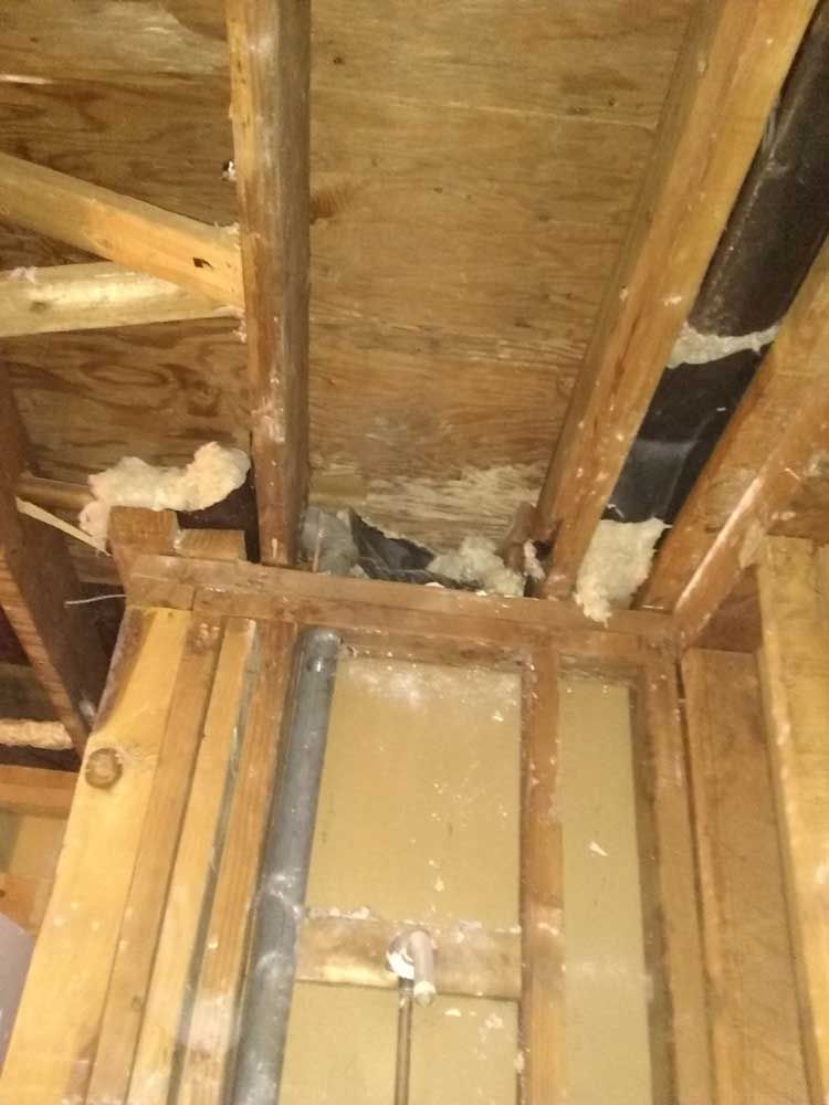 A wooden structure with a pipe coming out of the ceiling