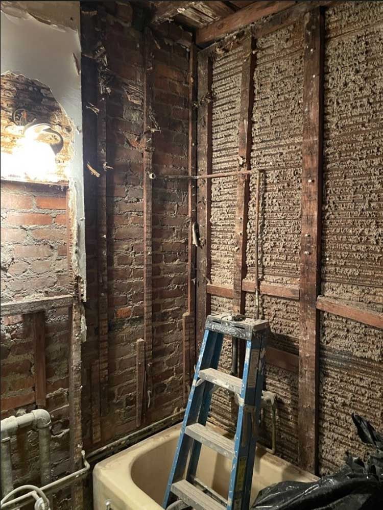 A bathroom with a bathtub and a ladder in it
