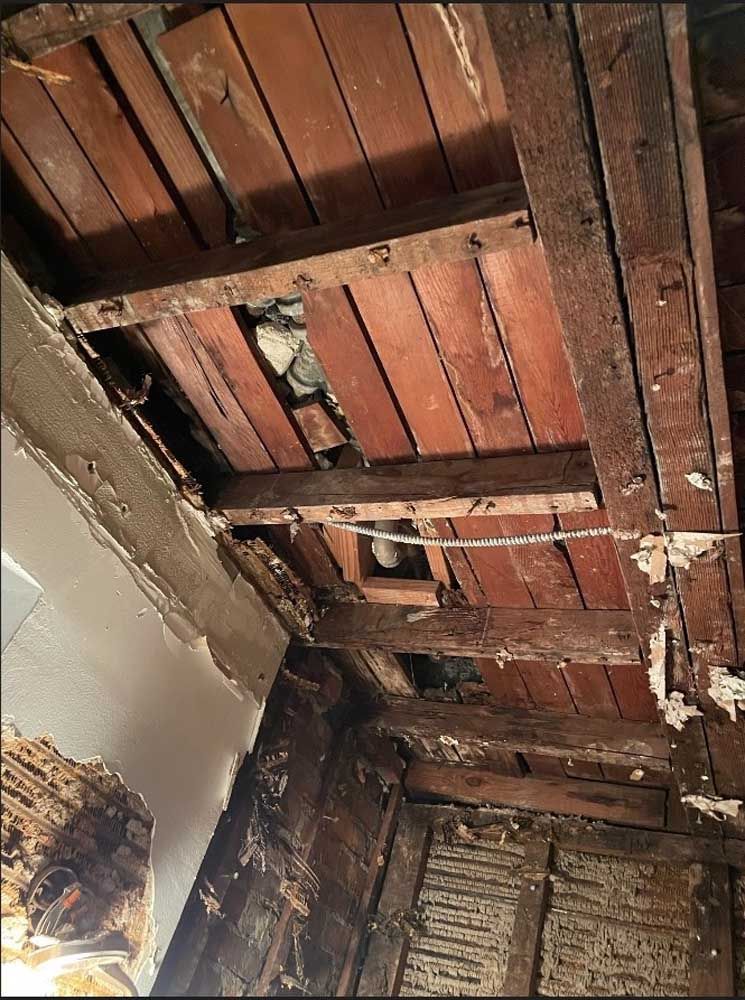 A picture of a wooden ceiling with a hole in it