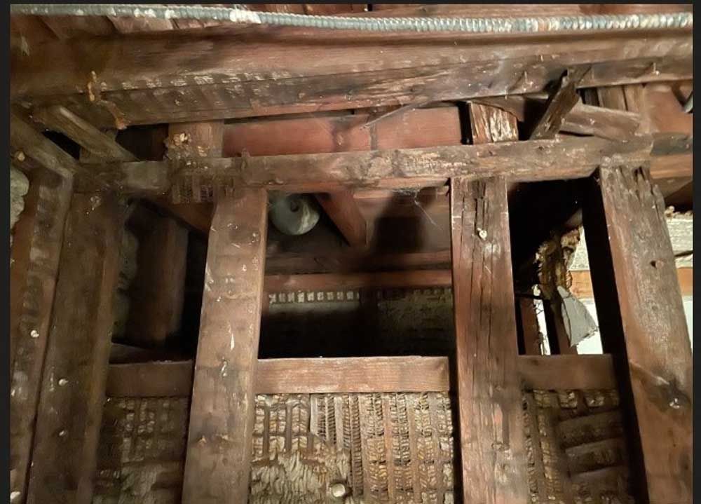 A wooden structure with a bell hanging from the ceiling