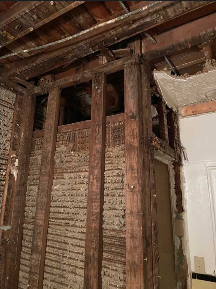 A room with a brick wall and wooden beams