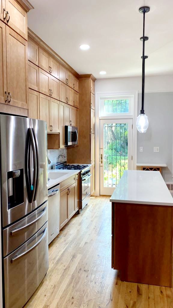 A kitchen with stainless steel appliances and wooden cabinets