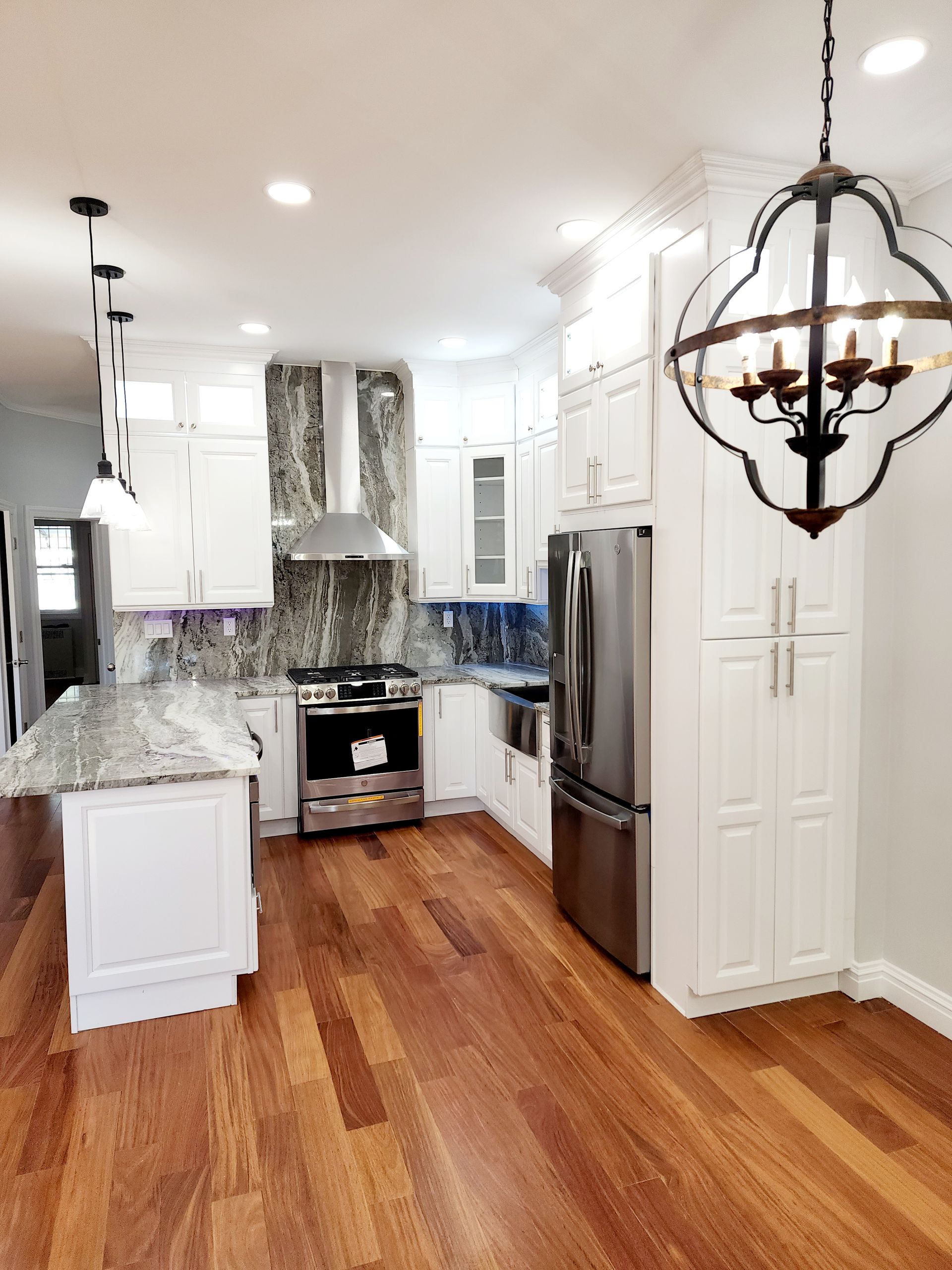 A kitchen with white cabinets and stainless steel appliances