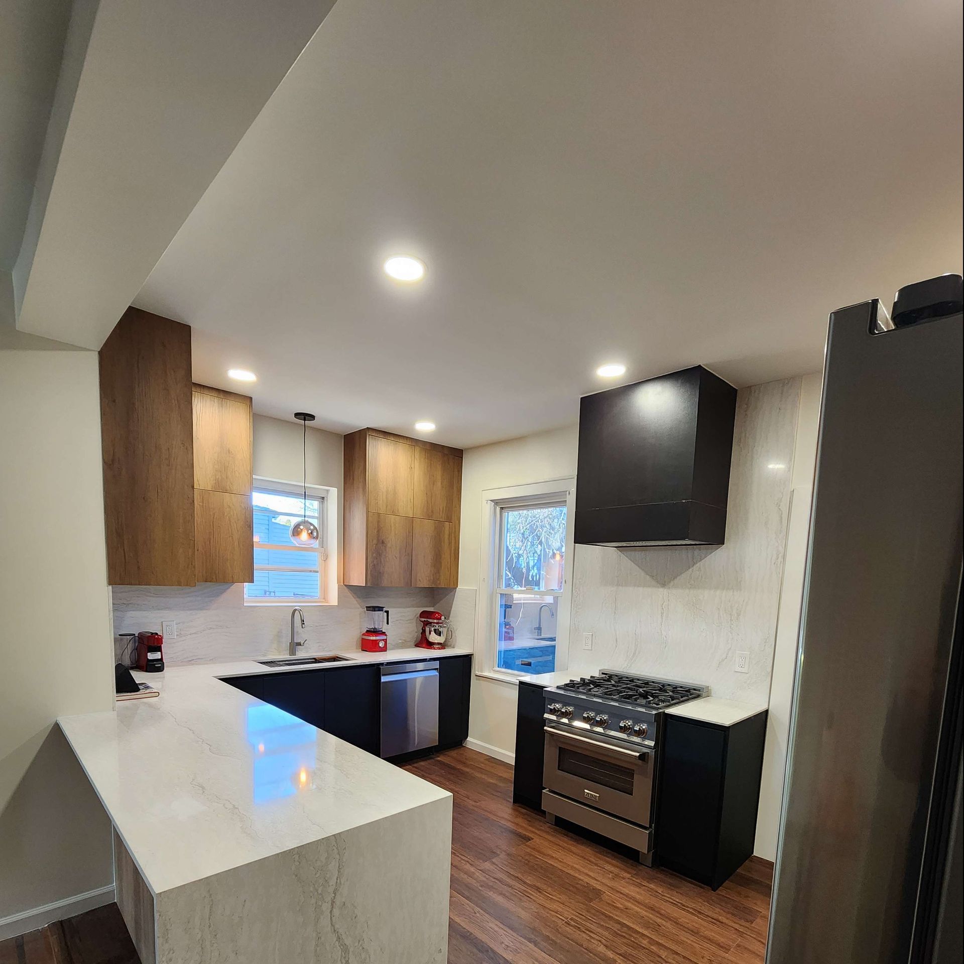 A kitchen with stainless steel appliances and wooden cabinets