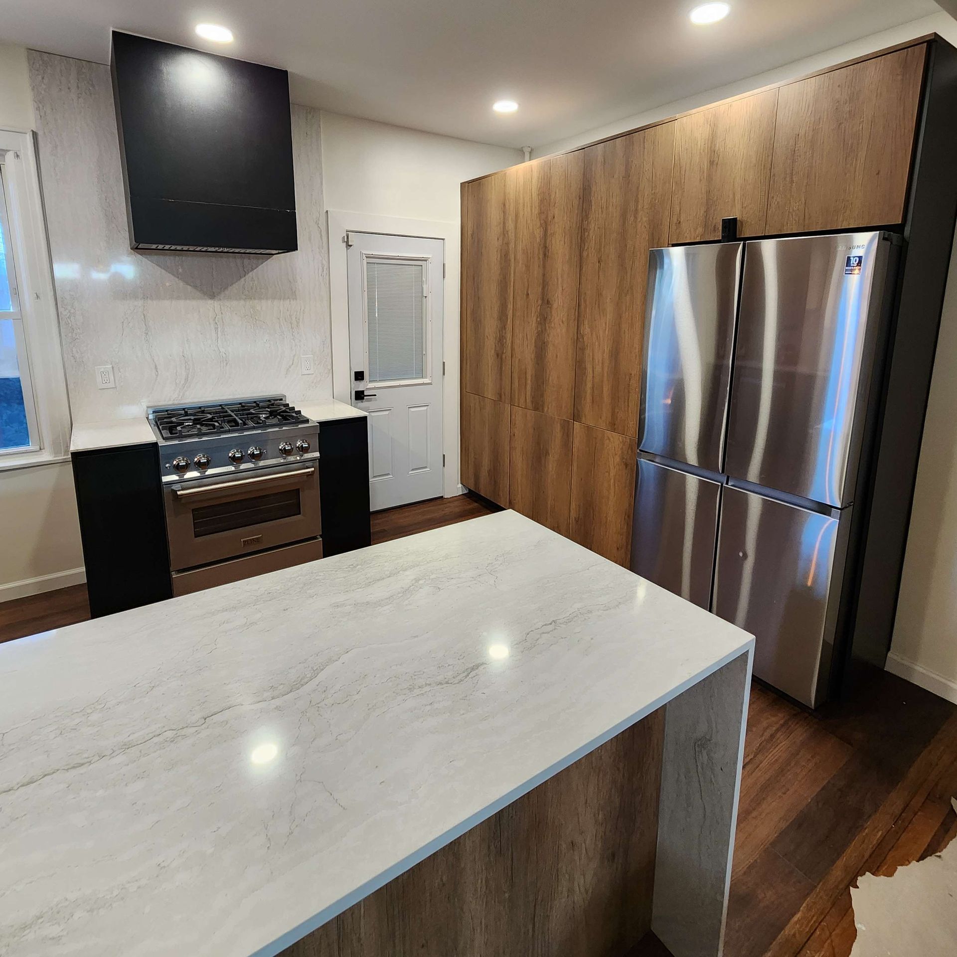 A kitchen with stainless steel appliances and a large island