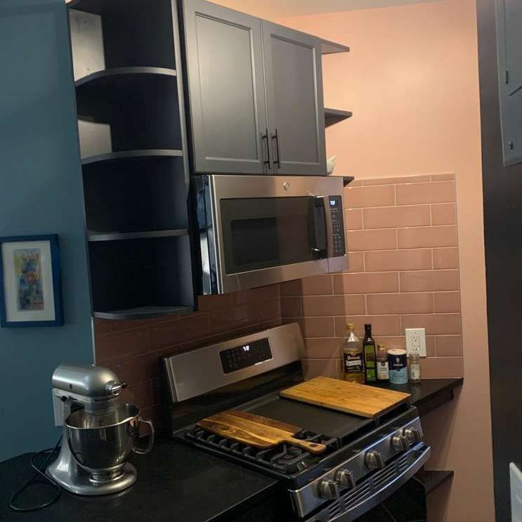 A kitchen with a stove top oven and a microwave