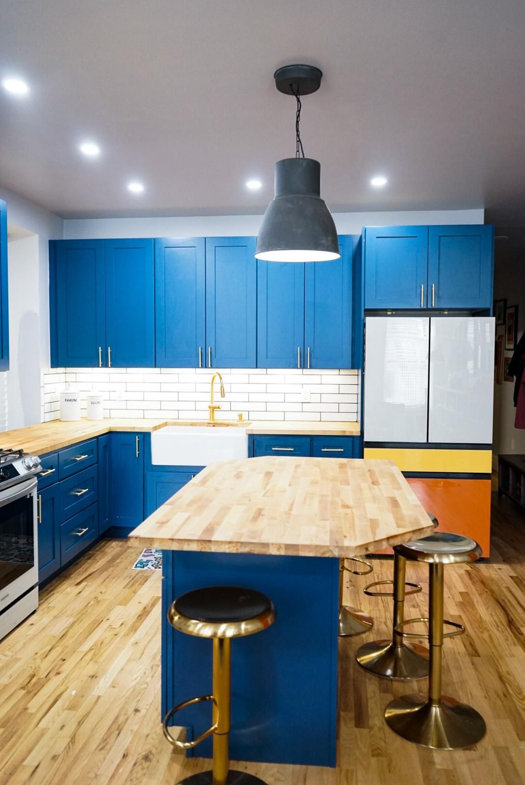A kitchen with blue cabinets and a wooden table