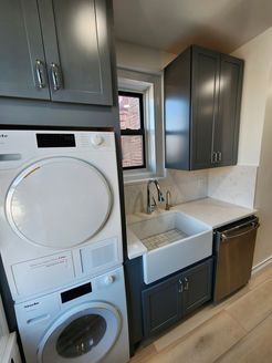 A laundry room with a washer and dryer stacked on top of each other