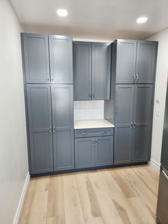 A kitchen with a lot of cabinets and a wooden floor
