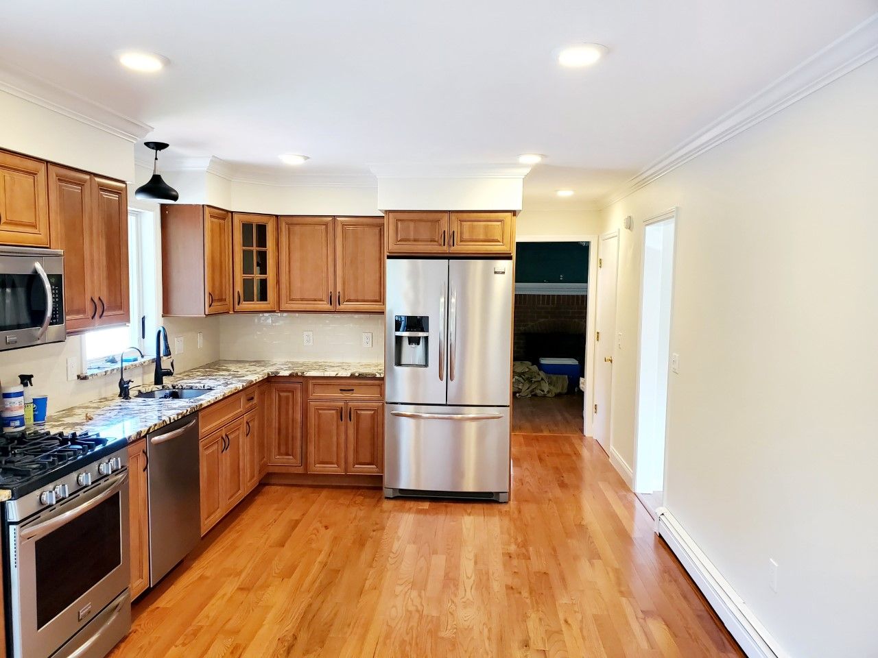 A kitchen with stainless steel appliances and wooden cabinets