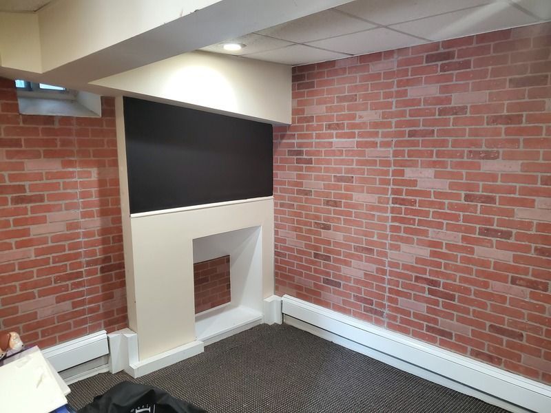 A room with a fireplace and a brick wall