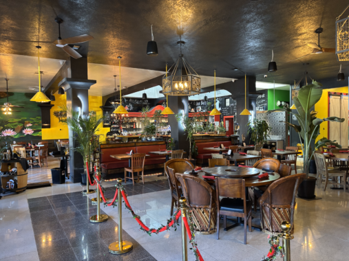 A large room with tables and chairs in a restaurant