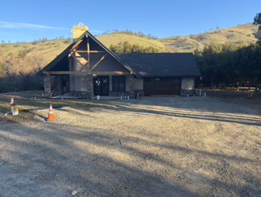 A house in the middle of a dirt road