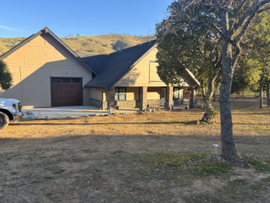 A white truck is parked in front of a house