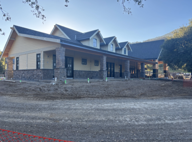 A large house with a large porch is being built